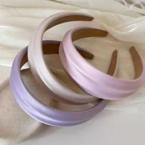 Close-up of three satin French headbands in lavender and champagne with thick padding