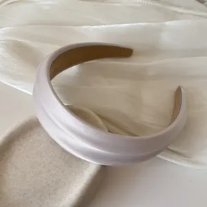 Close-up of French style wide satin headband with high top design for women.