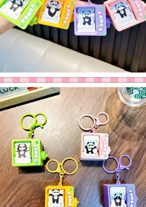 Close-up of colorful panda flipping animation machine keychains in four pastel colors