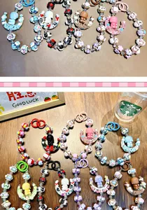 Detailed view of various colorful handmade beaded phone straps with cute moon girl charms.