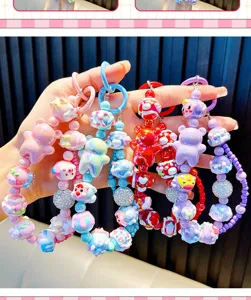 Close-up view of colorful beaded bear phone straps and keychains with cartoon characters