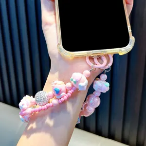 Handmade pink beaded phone strap featuring cute cartoon bears and a sparkling rhinestone bead