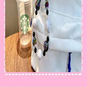 Detail of handmade beaded phone charm featuring cute rabbit and iridescent beads accessories