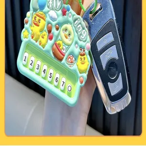 Close-up of cute yellow duck piano keychain with numeric keys on light green base