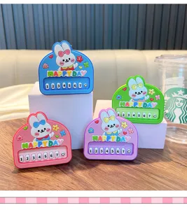 Detailed view of four colorful cartoon rabbit piano keychains with Happy Day text design.