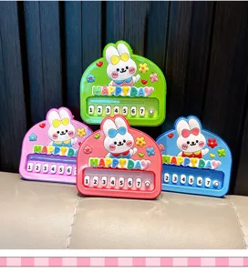 Detail view of colorful cartoon rabbit piano keychains in pink, blue, red and green colors.