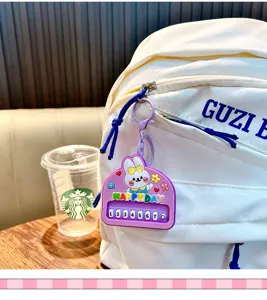 Cute purple rabbit keychain with piano keys hanging on a white backpack detail.