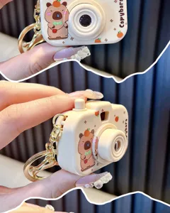 Close-up detail of cartoon Capybara projection camera keychain for bag decoration