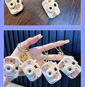 Close-up of cute Capybara cartoon camera keychains with projection feature