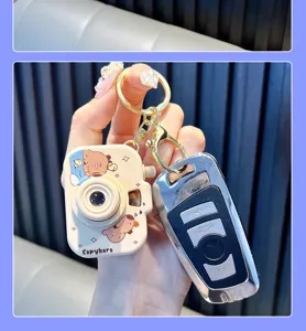 Detailed view of a cute Capybara toy camera keychain with luminous projection