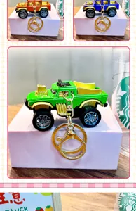 Detailed view of miniature green alloy pickup truck keychain toy car pendant.