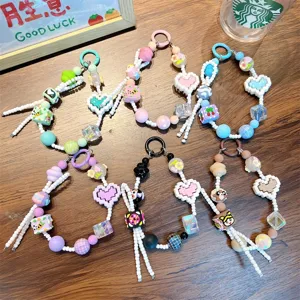 Set of colorful handmade beaded phone charms with pixel hearts and cute cartoon icons