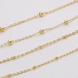 Detailed macro view of 18K gold plated satellite chain with small beads for DIY