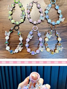 Macro detail of colorful crystal beaded butterfly phone straps and keychain accessories