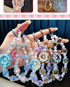 Detalle de charms de cuentas para móvil con colgantes de donut y cristales facetados.