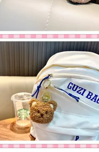 Close-up of a cute brown plush bear keychain pendant attached to a white backpack