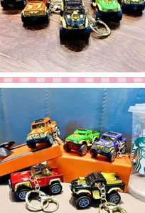 Detailed view of colorful alloy pickup truck keychains on orange gift boxes for boys