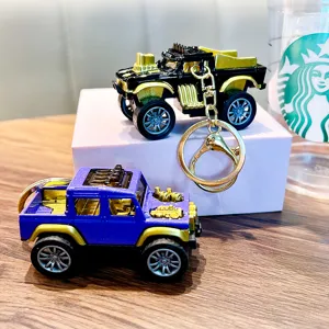 Pair of miniature alloy pull-back monster truck keychains in black and purple colors