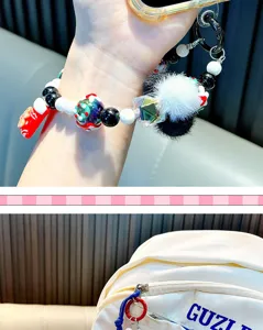 Colorful beaded Christmas charm strap used as a phone wristlet and bag accessory
