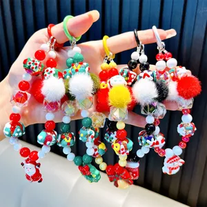 Festive Christmas-themed beaded phone straps and keychains with pom-poms and charms.