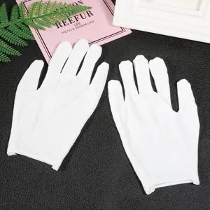 Detailed view showing the texture of white cotton work gloves for DIY and anti-sweat tasks