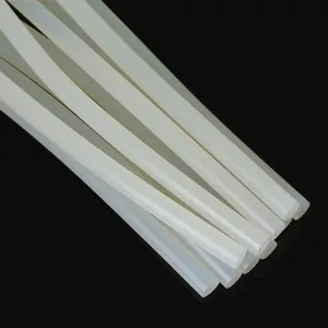 Detailed close-up view of translucent white hot melt glue sticks on solid black background