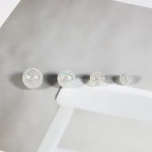 Detailed view of iridescent bubble beads in four different sizes for DIY crafts
