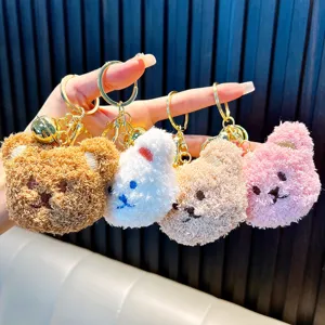 Set of four cute plush bear head keychains in brown, pink, white, and tan colors