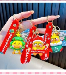 Detail view of cheerful yellow duck Christmas keychains with festive rubber charms.