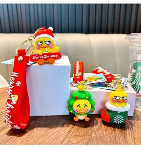 Festive Christmas-themed little yellow duck keychain pendants with merry holiday designs