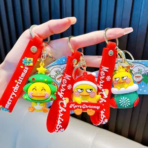 Set of three cartoon Christmas yellow duck keychains with festive red silicone wrist straps