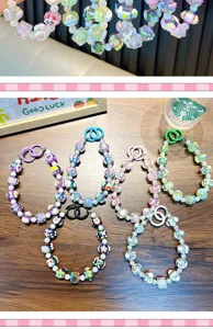 Detail view of colorful hand-painted beaded phone straps with unique pattern beads