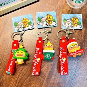 Set of three festive Christmas cartoon duck keychains featuring cute holiday designs