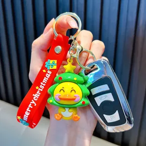 Cute cartoon yellow duck wearing a Christmas tree hat keychain with a red festive strap
