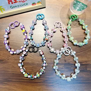 Set of five colorful hand-painted beaded phone straps with cute patterns and plastic rings