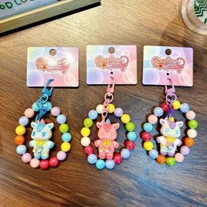 Set of three colorful beaded unicorn keychains with Rainbow Candy tags on wood