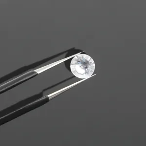 Close-up of stainless steel precision tweezers holding a clear round gemstone