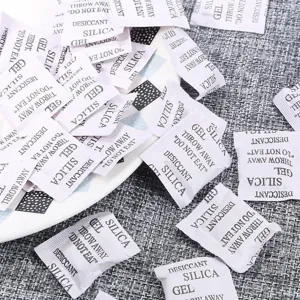Macro view of multiple white silica gel desiccant packets for moisture protection
