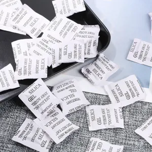 Detailed view of white silica gel desiccant packets for jewelry preservation.
