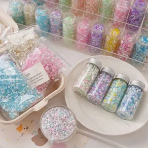 Detail shot of colorful glass seed beads in small glass jars for DIY jewelry making.