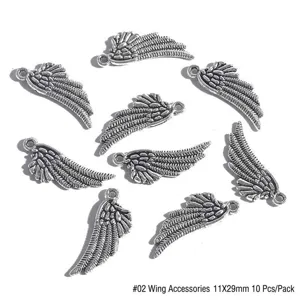 Detailed macro view of silver alloy angel wing charms for DIY jewelry making 11x29mm