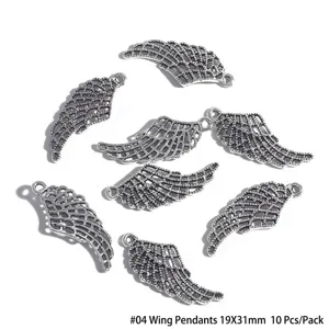 Detailed view of antique silver alloy wing charms for DIY jewelry making