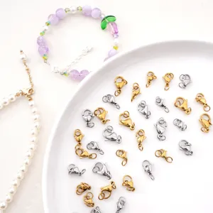 Detailed view of gold and silver stainless steel lobster clasps for DIY jewelry making.