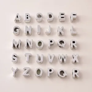 Close-up of UV silver-plated acrylic alphabet beads from A to Z for DIY jewelry making.