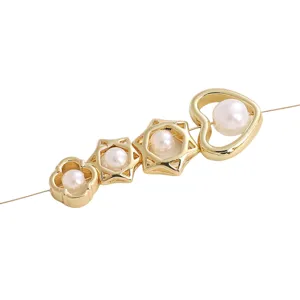 Macro detail of gold-plated heart and hexagram spacer beads with pearls for DIY jewelry