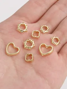 Selection of hollow gold hexagram, heart and flower beads for DIY jewelry making crafts