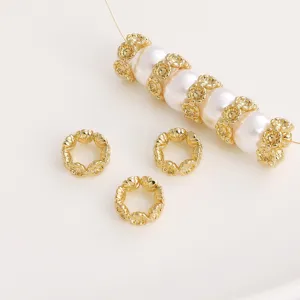 Close-up macro view of golden hollow flower spacer beads paired with white pearls