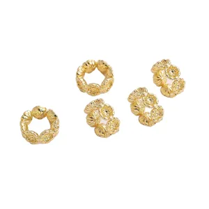 Detailed view of gold-plated plum blossom hollow spacer beads for DIY jewelry making projects