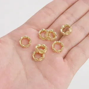 Detailed macro shot of gold hollow floral spacer beads for handmade DIY jewelry making.