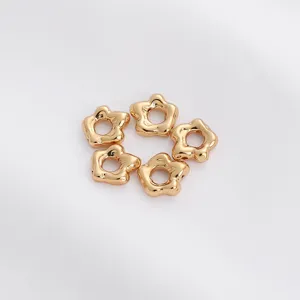 Set of five gold-toned hollow flower spacer beads for DIY jewelry making on white